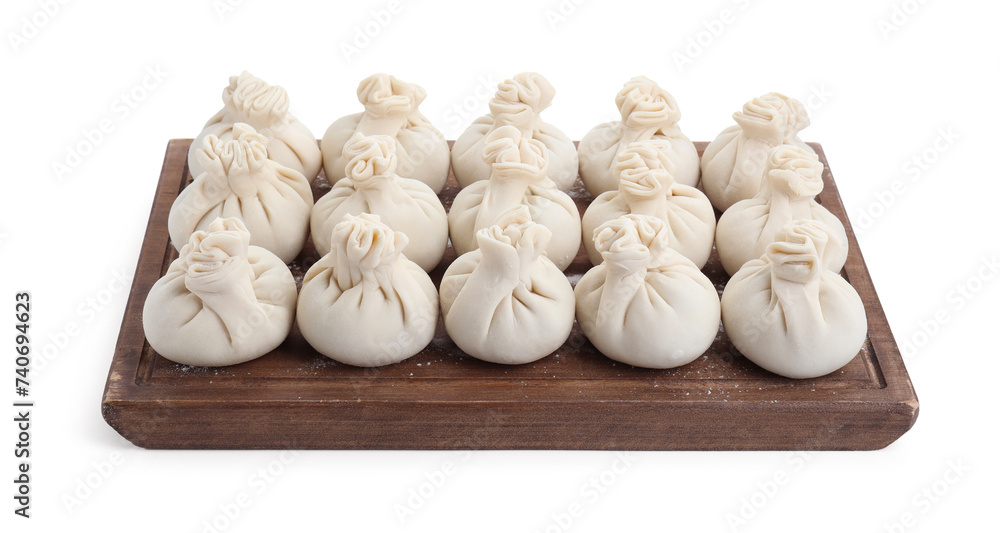Fototapeta premium Wooden board with uncooked khinkali (dumplings) isolated on white. Georgian cuisine