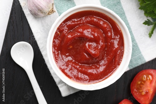 Organic ketchup in bowl on table, flat lay. Tomato sauce