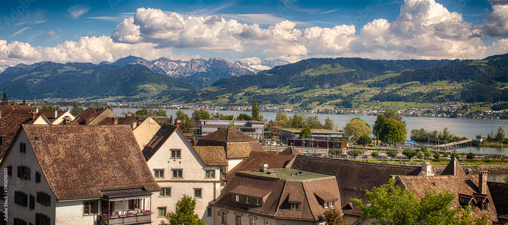 Rapperswil, Switzerland June 1 2019: View of Rapperswil from the castle walls. Roofs of the medieval old town of Rapperswil and alpine ranges in the background