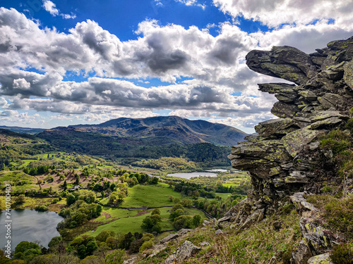 The mountain view of a green countryside valley from Loughrigg Fell hiking route in Lake District, Cumbria, England, UK photo