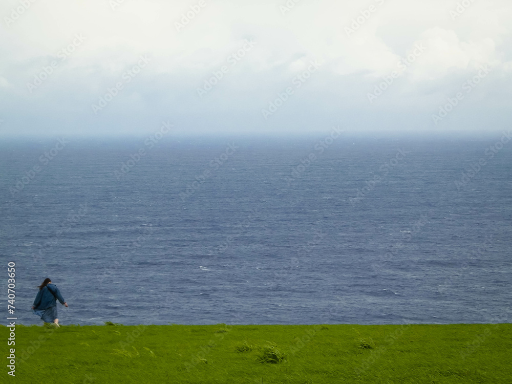 Tourist at cliff, Sao Miguel island, Azores travel concept. Tourist at cliff, Sao Miguel island, Azores travel concept.