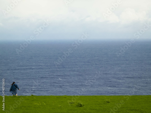 Tourist at cliff, Sao Miguel island, Azores travel concept.