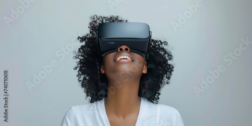 Young woman immersed in virtual reality experience wearing VR headset modern depiction of futuristic technology and networked entertainment showcasing joy and innovation of digital simulation photo