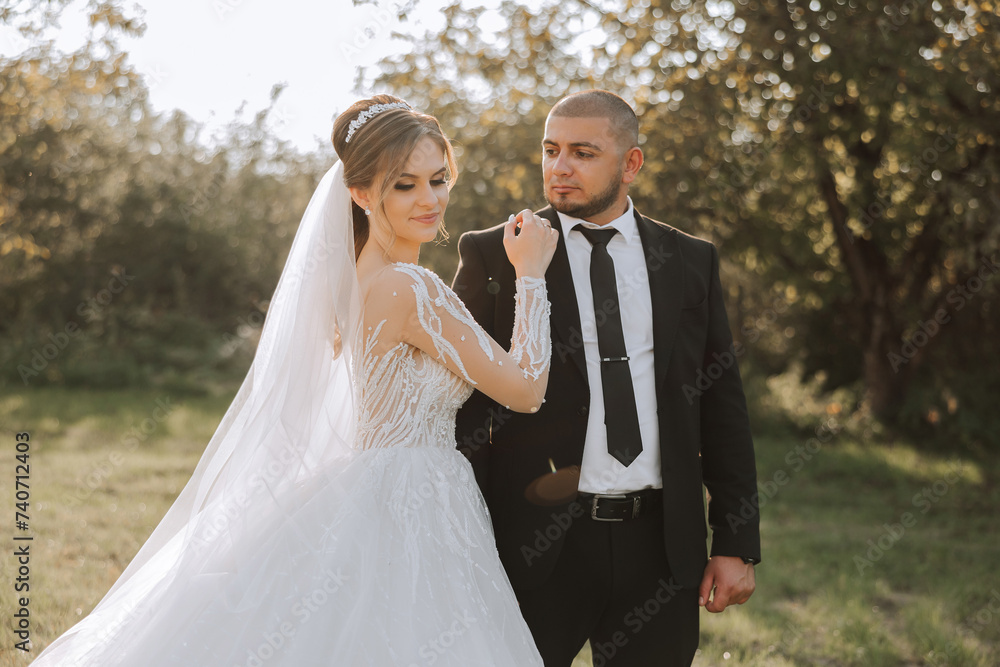 The bride and groom look at each other on their wedding day. Over the shoulder shot of a wedding couple. Tenderness and love in the eyes. The bride and groom look at each other on their wedding day. Over the shoulder shot of a wedding couple. Tenderness and love in the eyes.