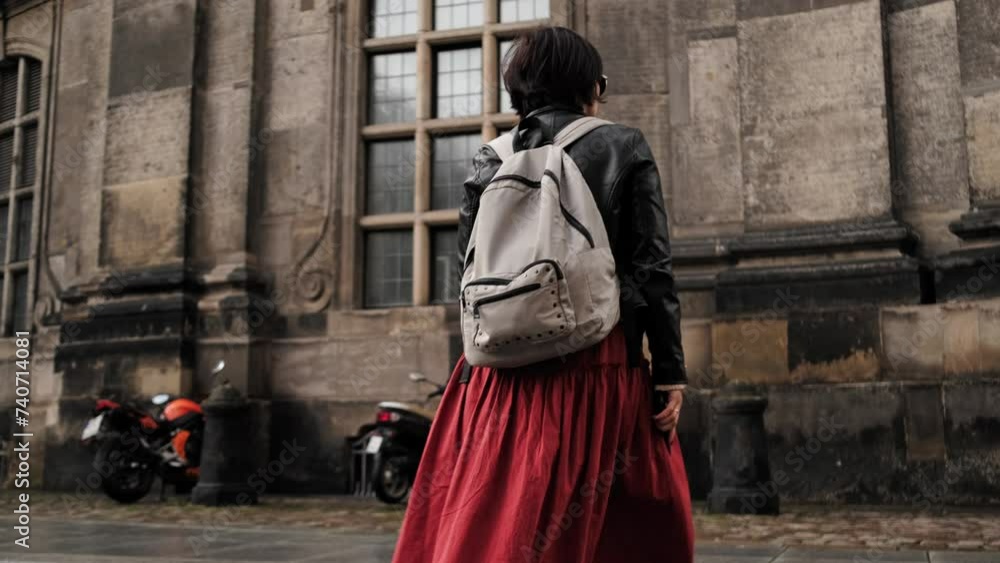 Stylish Woman Strolls Through Historical Touristic Streets In Dresden, Backpack In Tow Stylish Woman Strolls Through Historical Touristic Streets In Dresden, Backpack In Tow