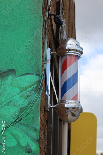 Barber pole on side of building
