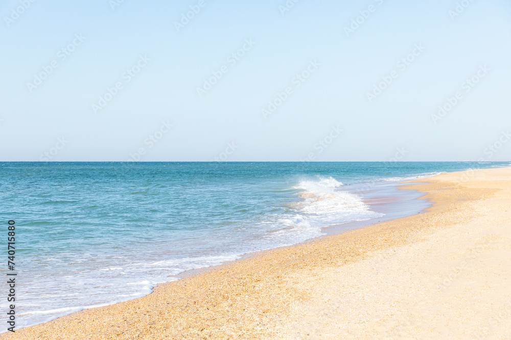 Soft blue sea and ocean wave on clean sandy beach. Summer vacation concept.