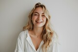 Blonde Woman in White Shirt Smiling Happily Against Neutral Background. Concept Portrait Photography, Happy Woman, Blonde Hair, White Shirt, Neutral Background