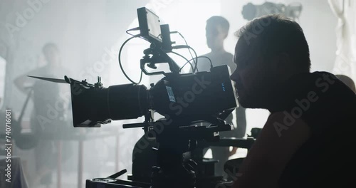 The cameraman with a professional movie camera at work.
