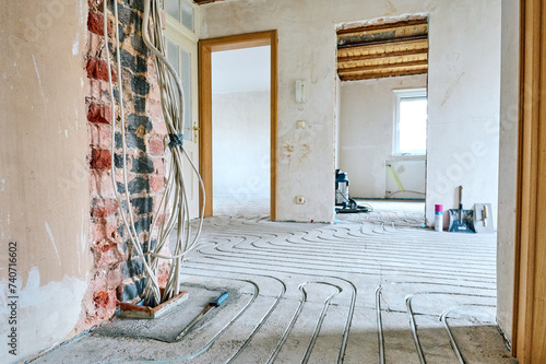 Fußbodenheizung wird in Estrich eingefräst bei einer Renovierung von Einfamilienhaus.  © zenturio1st