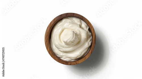 Sour cream in a wooden bowl isolated on white. Dairy product. Top view.