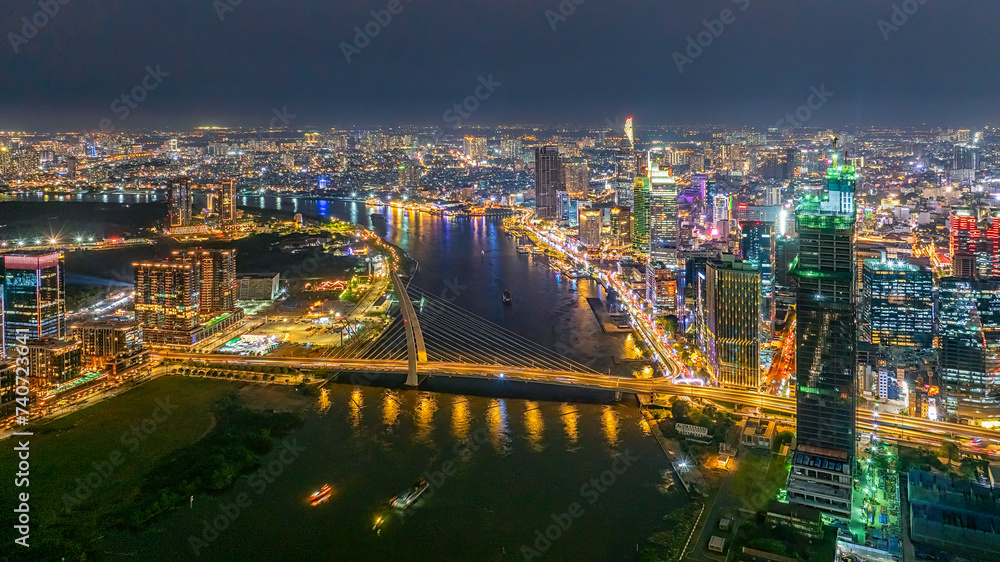 Obraz premium Top view aerial photo from flying drone of a Ho Chi Minh City with development buildings, transportation, energy power infrastructure. Financial and business centers in developed Vietnam.
