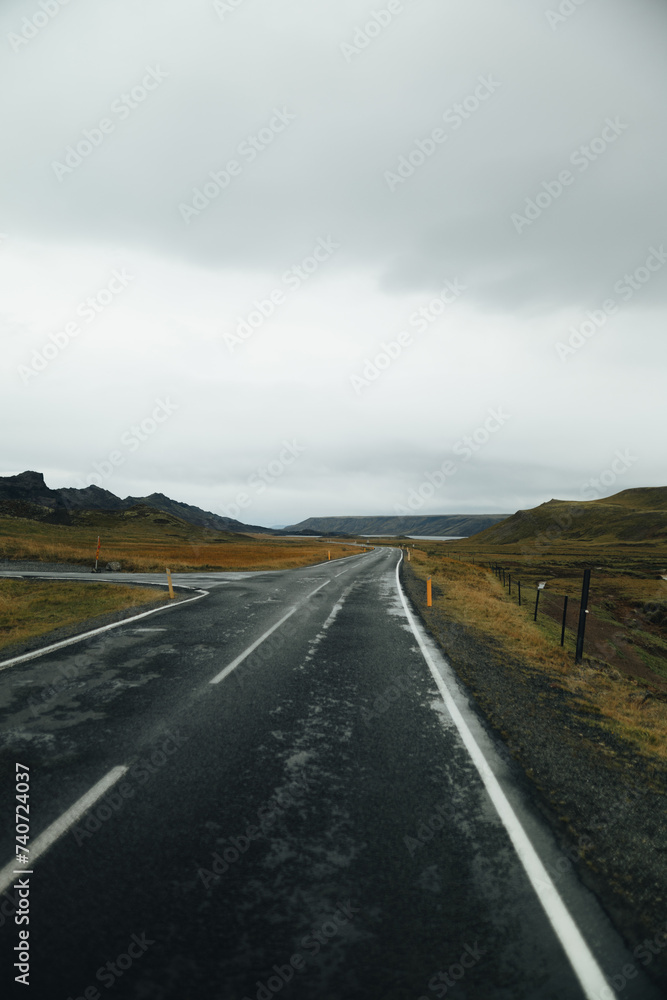 Rain-soaked road winding through Icelandic landscape Rain-soaked road winding through Icelandic landscape