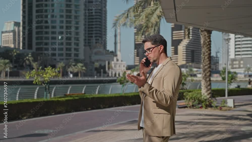 handsome busy man calling by phone and talking on street in business district, portrait of rich man handsome busy man calling by phone and talking on street in business district, portrait of rich man