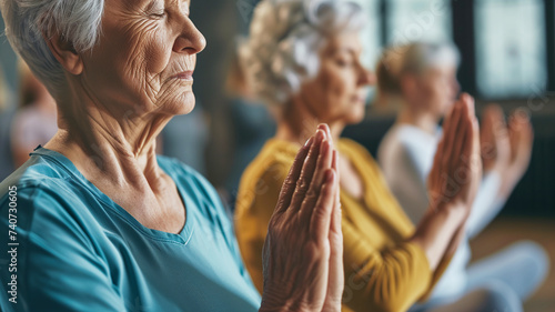 Older women practice yoga, meditate in yoga classes and lead an active and healthy lifestyle. Retirement hobbies and leisure activities for the elderly. Bokeh in the background. photo
