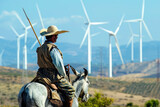 Donquijote mit Lanze auf einem Esel bereit zum Kampf gegen Windkraftanlagen