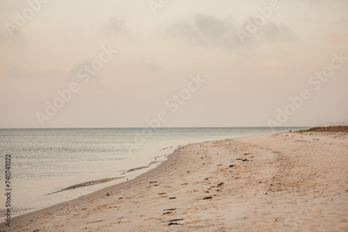 The serene beach on a cloudy sunset in Wakulla, Florida.