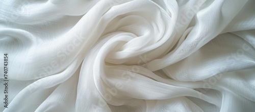 A detailed wood carving resembling a vortex pattern on a white cloth, resembling the texture of peach fur