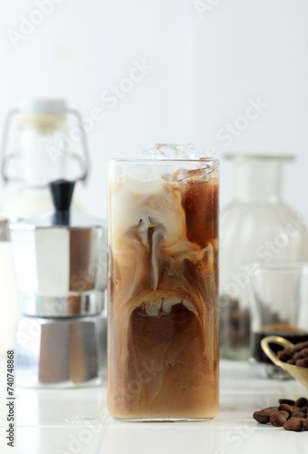 Glass of Delicious Ice Cold Brew with Milk and Coffee Beans