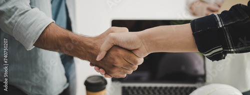 construction worker and contractor. Client shaking hands with team builder in renovation site.