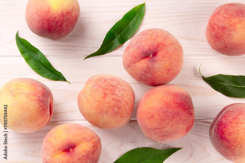 Fresh peaches on a wooden table. Summer peach fruit background. Fresh peaches on a wooden table. Summer peach fruit background.
