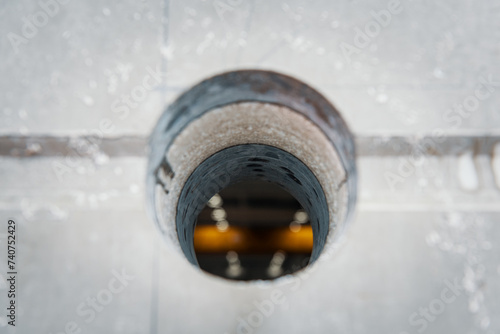 Drilled hole into a concrete wall with core driller
