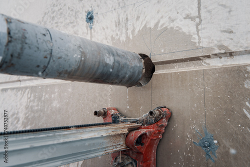 Drilling a hole into a concrete wall with core driller