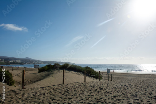 A path through the dunes to the sea with sun