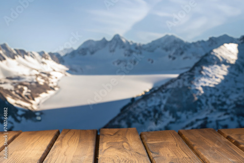 wooden table for display product, tables of wood for showing goods, empy surface, mountains landscape on the background photo