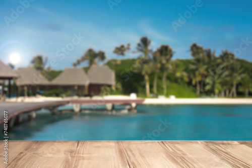 wooden table for display product, tables of wood for showing goods, empy surface,  tropical beach landscape on the background © Alessandro
