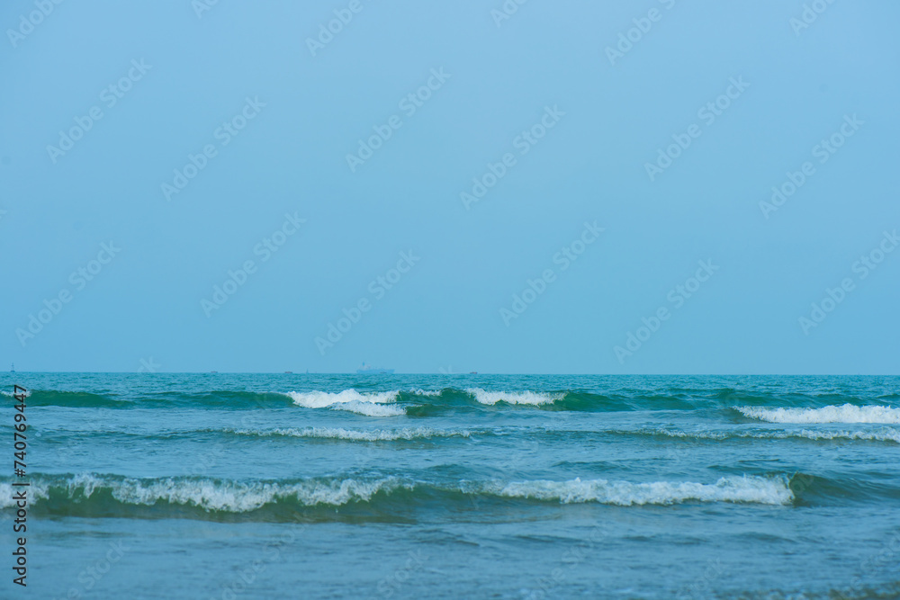 Waves on the beach. Blue sea wave. Blue water surface texture with ripples, splashes, and bubbles. Abstract summer banner background Water waves in sunlight with copy space cosmetic moisturizer.