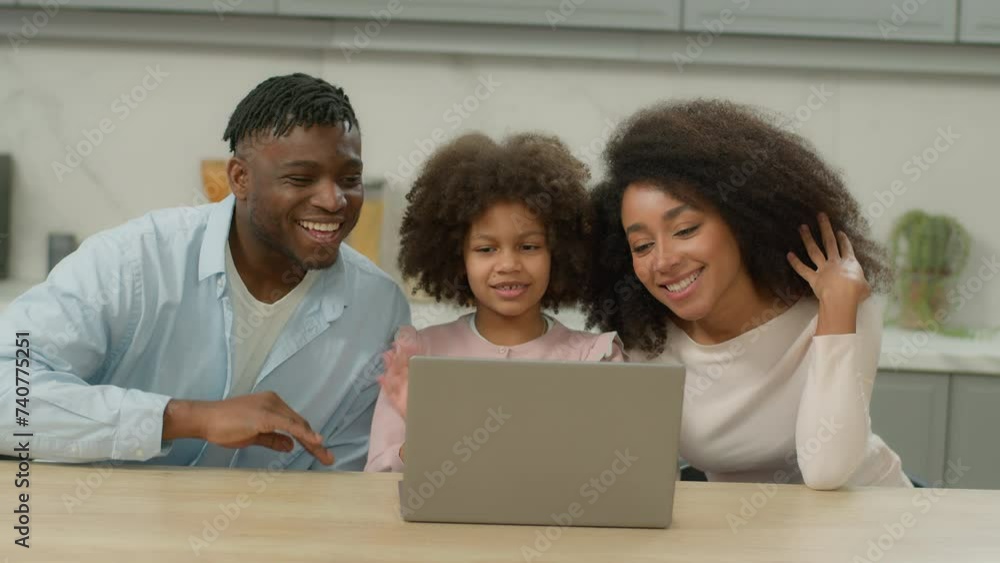 African American happy parents little child talking distant communication pc kitchen video call laptop family waving hello father mother with kid daughter girl talk online computer conference at home African American happy parents little child talking distant communication pc kitchen video call laptop family waving hello father mother with kid daughter girl talk online computer conference at home