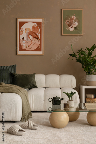 Cozy vertical composition of living room interior with mock up poster frame, modular sofa, design glassy coffee table, plants, decorations and personal accessories. Home decor. Template. photo