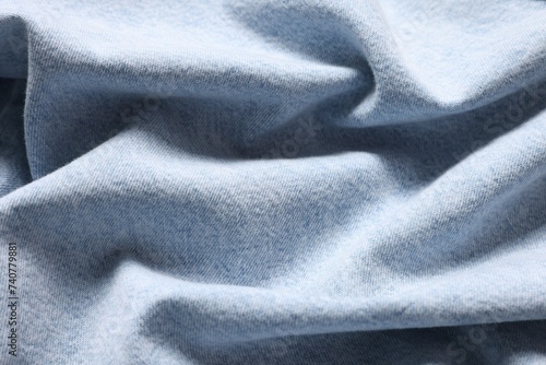 Texture of light blue crumpled fabric as background, top view