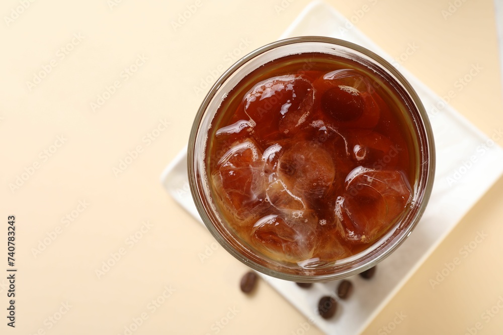 Refreshing iced coffee in glass on beige table, top view. Space for text Refreshing iced coffee in glass on beige table, top view. Space for text