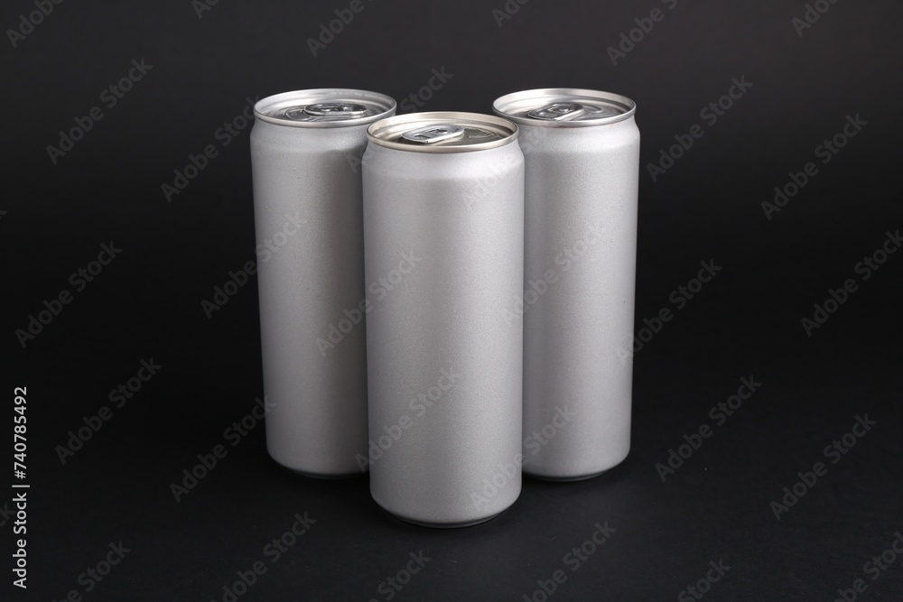 Energy drinks in cans on black background Energy drinks in cans on black background