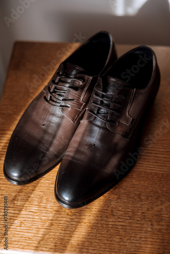 brown men's shoes. Stylish comfortable men's boots with laces. Comfortable men's shoes. Details of the groom © Vasil