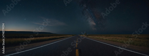 Isolated country road with an empty asphalt surface, framed by the tranquil night sky. 