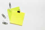 colorful sticky notes with paperclips and copy space over white