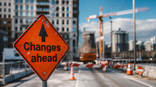 The "Changes ahead" sign on a city's waterfront promenade, with ongoing development of recreational spaces behind, Changes ahead, blurred background, with copy space