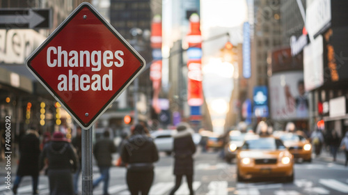 The "Changes ahead" sign at a busy city intersection, with the hustle and bustle of pedestrians and traffic behind, Changes ahead, blurred background, with copy space