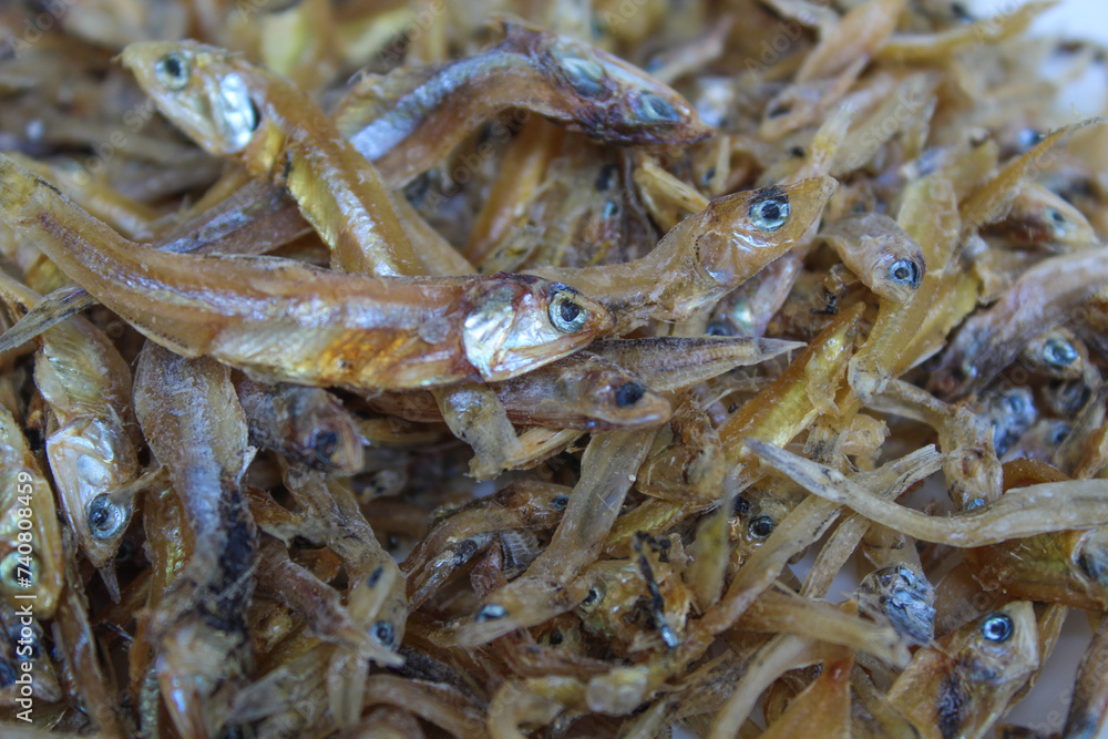 Background texture of dried anchovy fish, uncooked. Preserved with salt Background texture of dried anchovy fish, uncooked. Preserved with salt