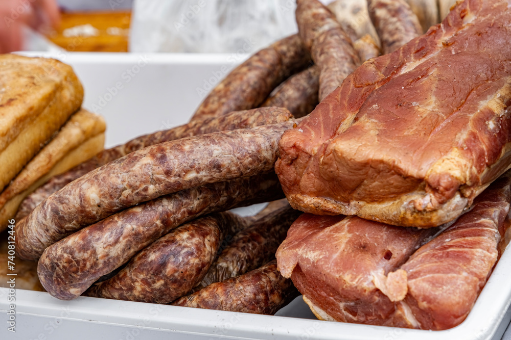 image with traditional Romanian winter holidays meat foods for sale in an outdoors market in Sibiu, Romania. image with traditional Romanian winter holidays meat foods for sale in an outdoors market in Sibiu, Romania.