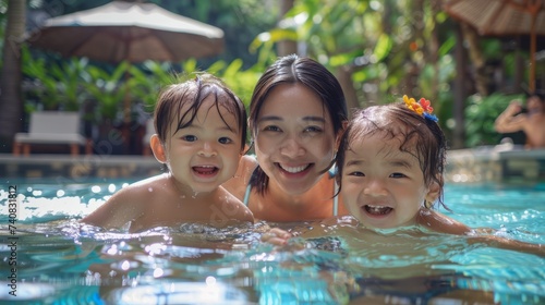 Mother teaching cute baby how to swim in a swimming pool. Cute smiling child having fun swimming and diving in the pool at the resort on summer vacation. ai