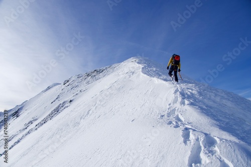 skier on the top of mountain, Vaiuga Peak, Fagaras Mountains, Romania © Ghidu