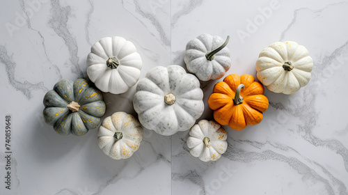 A group of pumpkins on a light gray color marble