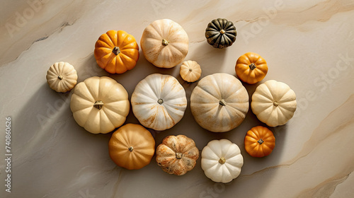 A group of pumpkins on a beige color marble