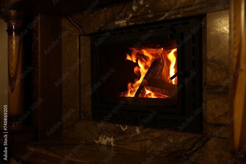 Fireplace with burning wood in darkness at home Fireplace with burning wood in darkness at home