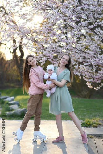 Mom and two daughters in the park. Mom takes care of her two daughters. Mothers Day