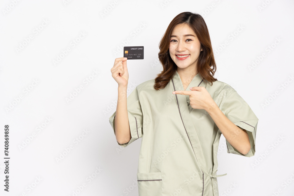 Young Asian woman patient smiling and showing credit card isolated on white background, Insurance card concept Young Asian woman patient smiling and showing credit card isolated on white background, Insurance card concept
